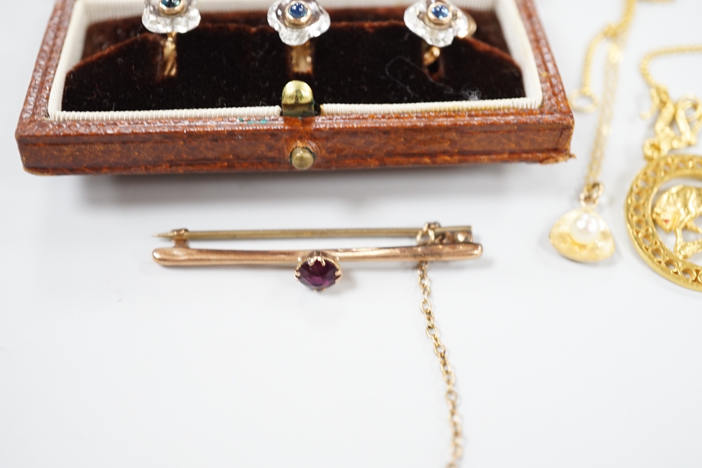 A small collection of jewellery to include a yellow metal Taurus medallion, a small yellow metal and gem set bar brooch, a 9ct gold and cultured pearl pendant and an Austro Hungarian yellow metal, paste and cabochon set